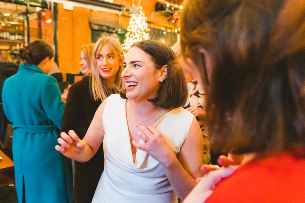 Short hair bride laughs with friends