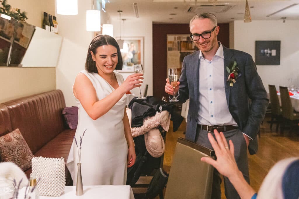 Bride and groom cheers in family Dublin city wedding