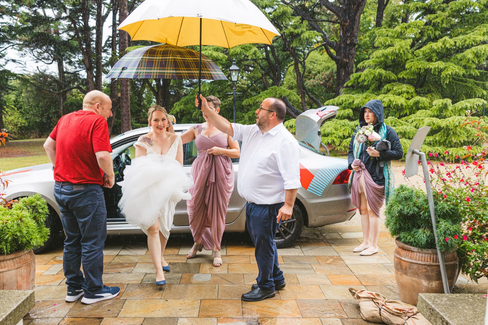 Umbrellas on rainy wet wedding day